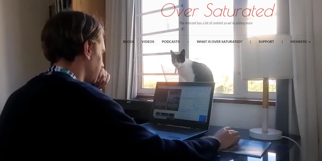 Image for the First YouTube Video on the Over Saturated channel - Tyrone working with a cat in front of his laptop