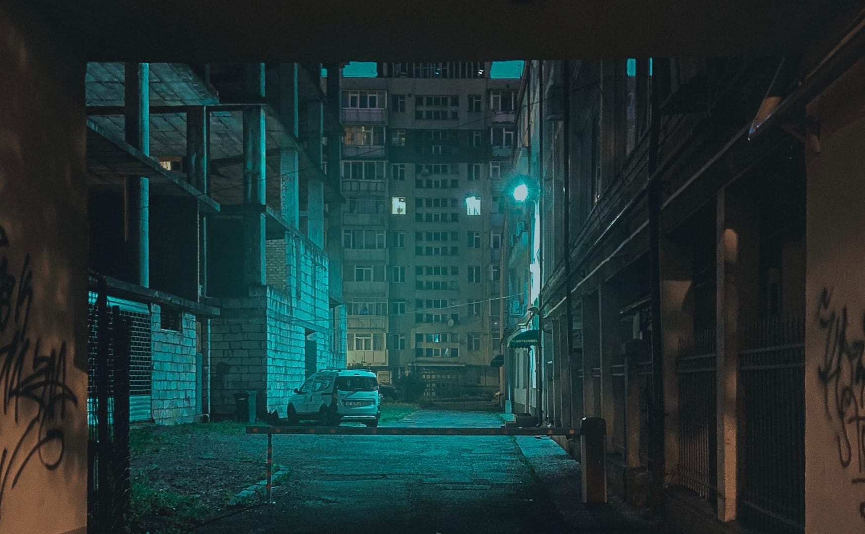 A car in a dilapidated part of a city