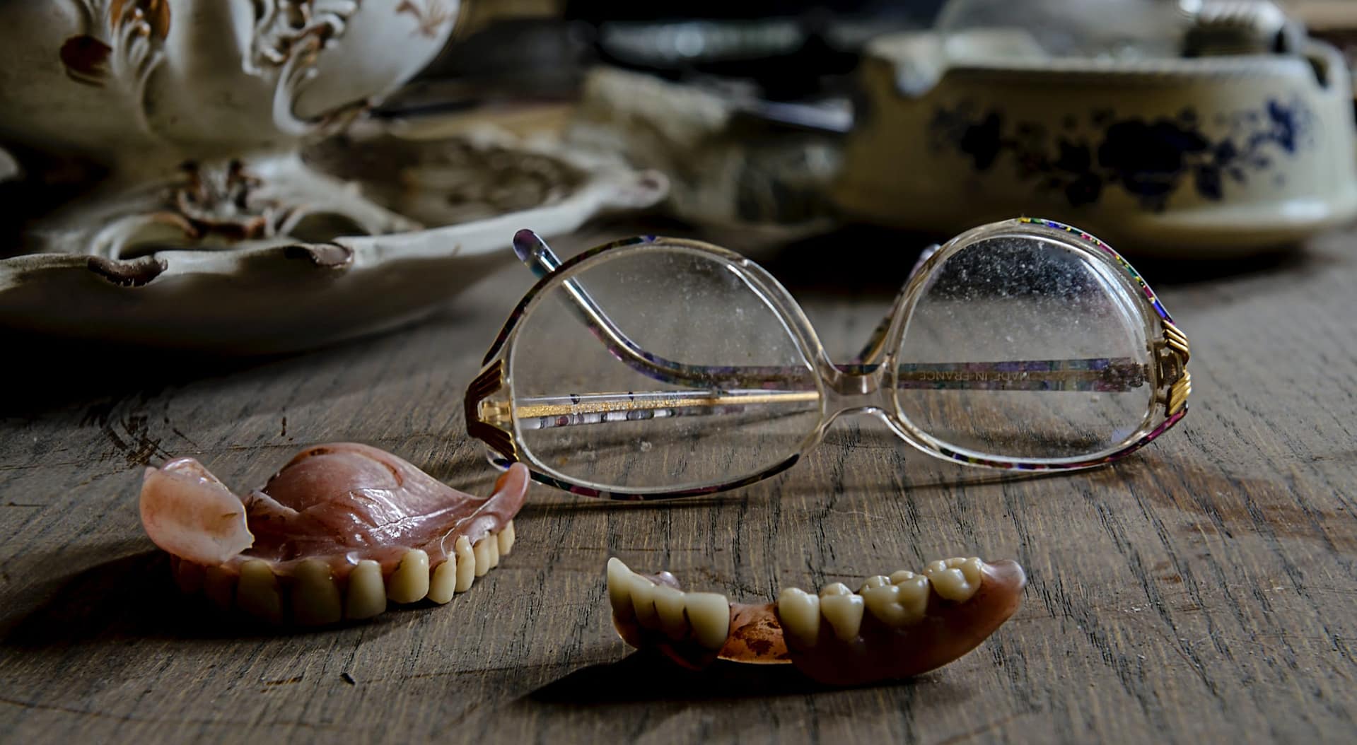 Dentures lying next to glasses