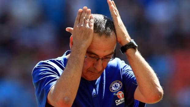Upset Sarri tapping his head