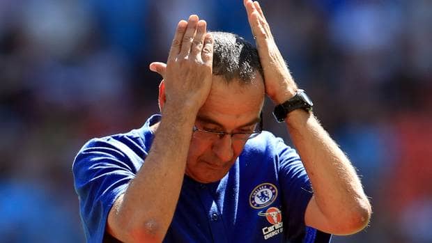 Upset Sarri tapping his head