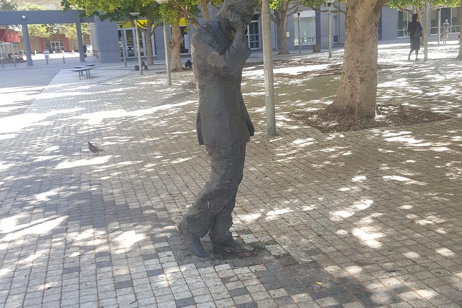 Statue of a man walking and talking on the phone in Cape Town