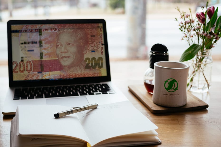Computer and note book representing making money online in South Africa