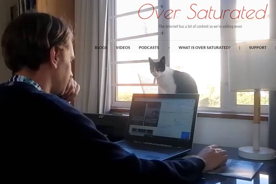 Image for the First YouTube Video on the Over Saturated channel - Tyrone working with a cat in front of his laptop