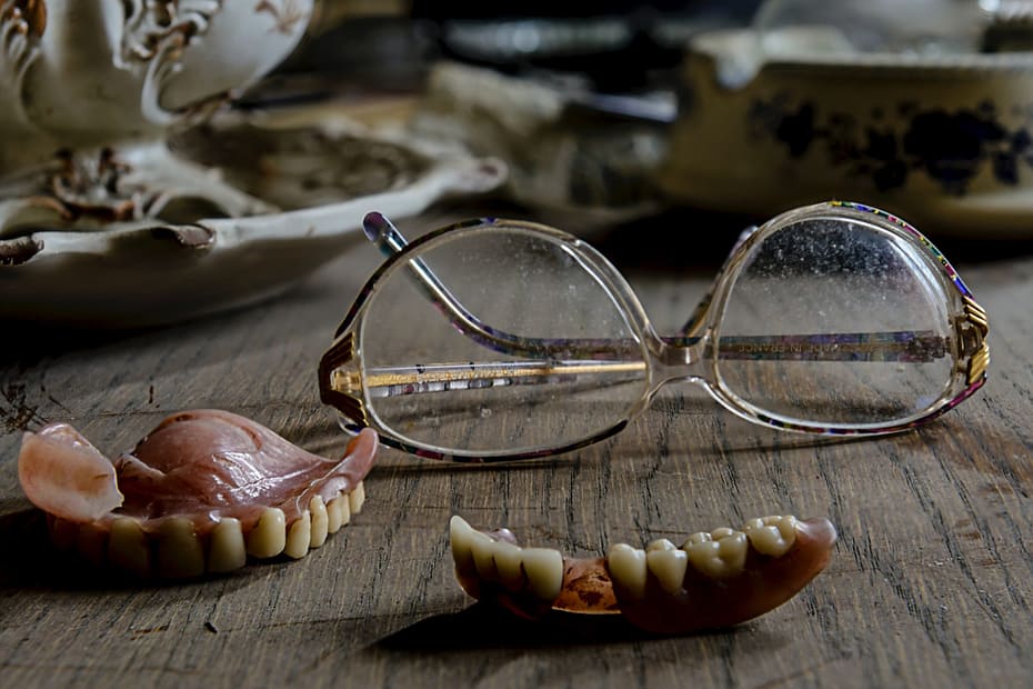 Dentures lying next to glasses